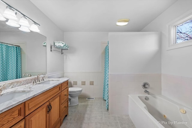 bathroom with a bathtub, vanity, tile walls, tile patterned flooring, and toilet