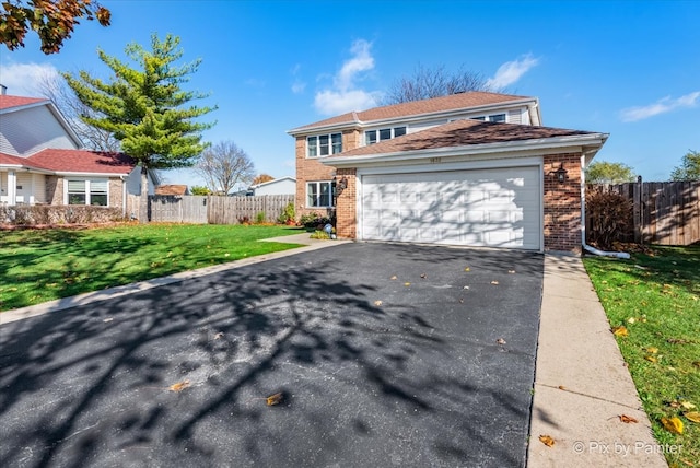 view of front property featuring a front yard and a garage