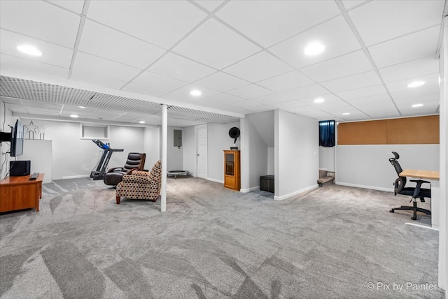 interior space featuring a paneled ceiling and light colored carpet