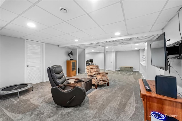 interior space with carpet flooring and a paneled ceiling