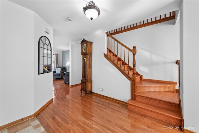 staircase featuring wood-type flooring