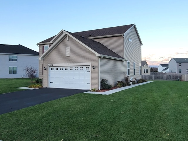 property exterior at dusk with a yard