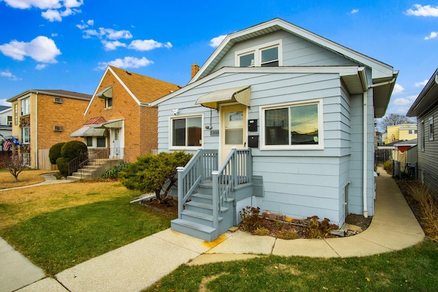 bungalow-style home featuring a front yard