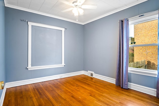 unfurnished room with ceiling fan, wood-type flooring, and ornamental molding