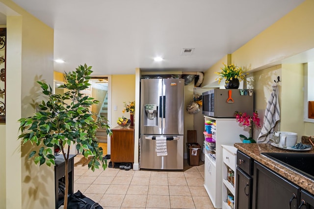 kitchen featuring sink, light tile patterned floors, and stainless steel appliances