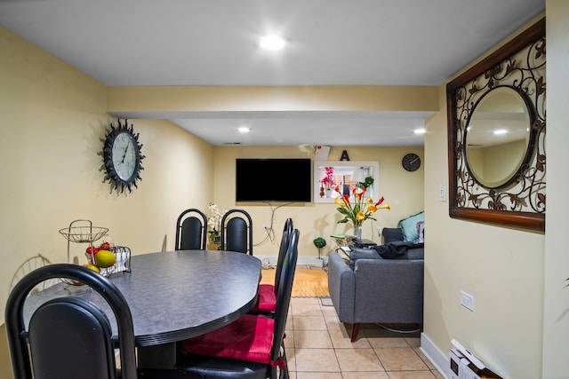 dining room with light tile patterned flooring and a baseboard heating unit