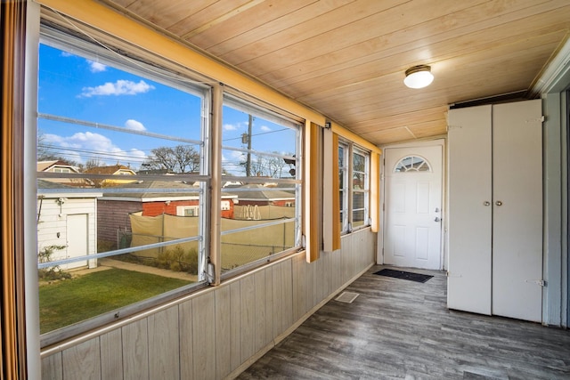 unfurnished sunroom with wood ceiling