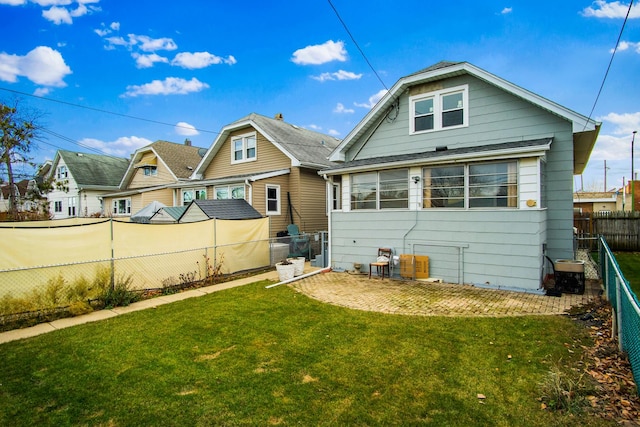 rear view of property with a yard