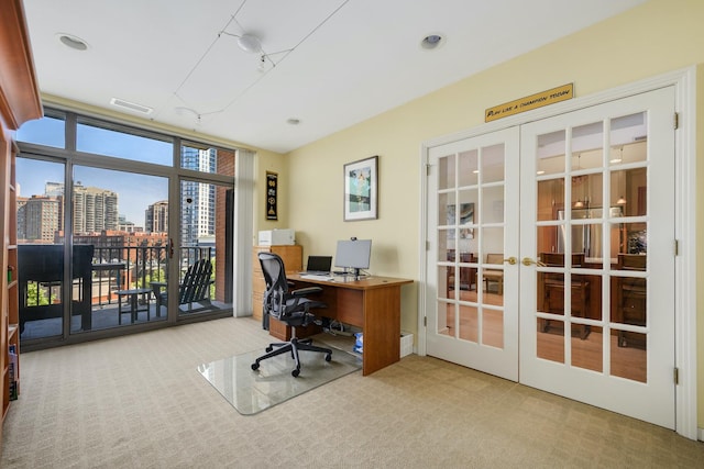 office space featuring light carpet, french doors, and expansive windows