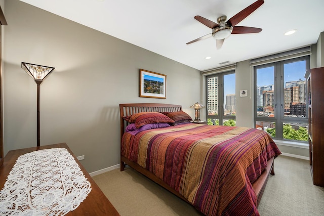 bedroom featuring multiple windows, light carpet, access to exterior, and ceiling fan