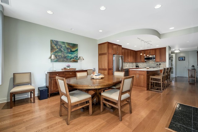 dining room with light hardwood / wood-style flooring