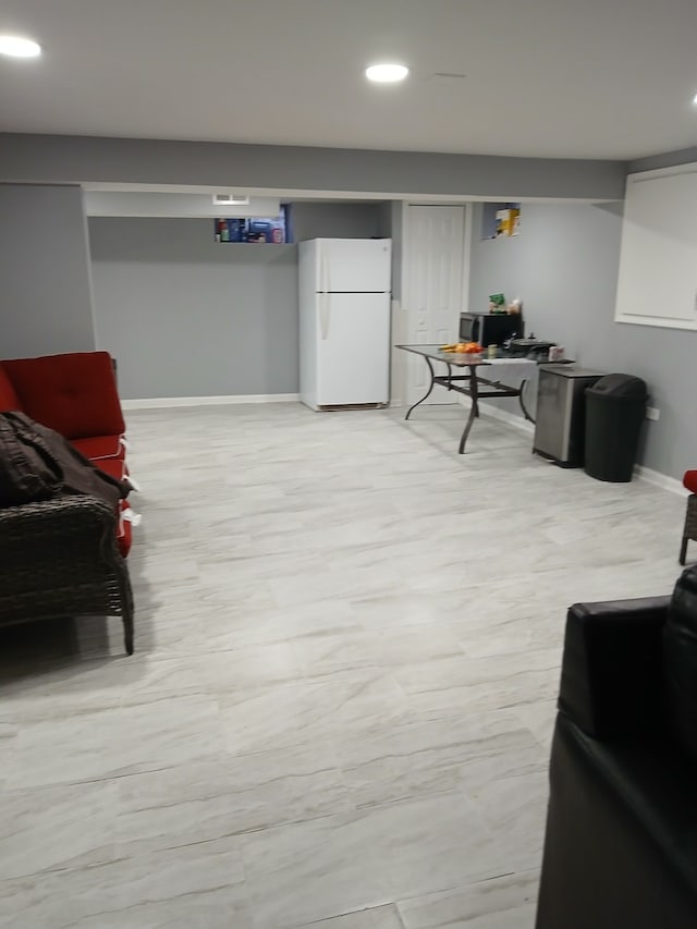 basement featuring white fridge