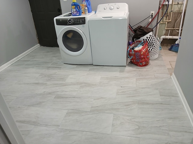 laundry room featuring washing machine and clothes dryer