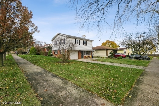 front of property with a garage and a front lawn