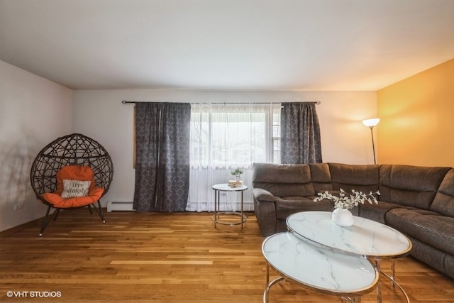 living room featuring wood-type flooring and a baseboard radiator