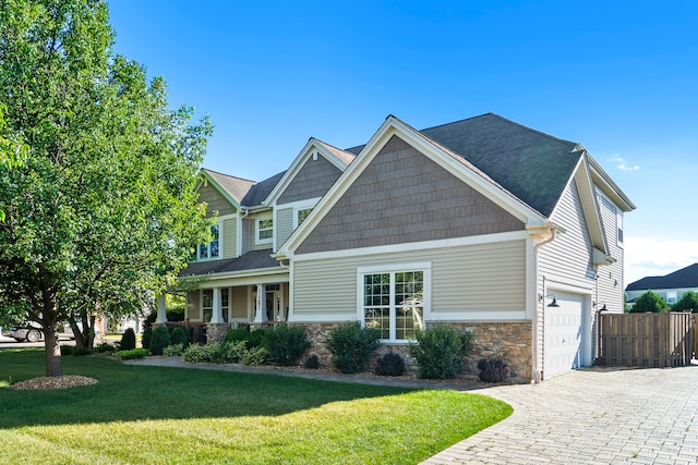 craftsman-style home with a front lawn and a garage