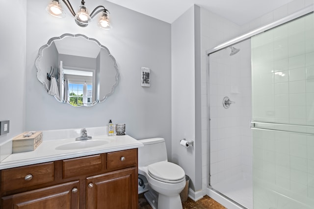 bathroom with toilet, vanity, and an enclosed shower