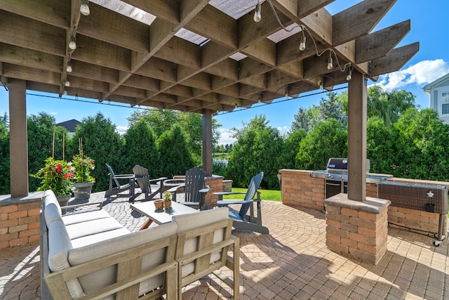 view of patio with an outdoor kitchen and a grill