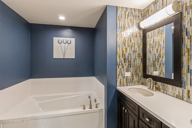 bathroom featuring vanity and a tub to relax in