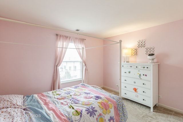 bedroom featuring light colored carpet