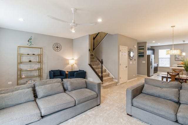 carpeted living room with ceiling fan