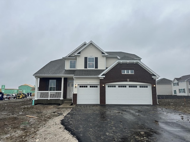 view of front facade featuring covered porch and a garage