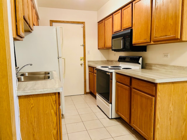 kitchen with white electric range, sink, and light tile patterned floors