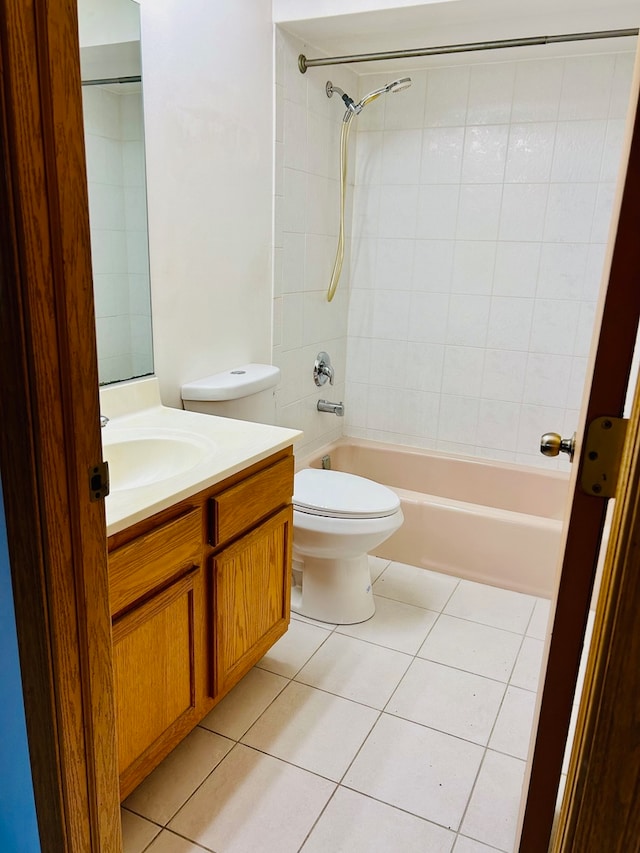 full bathroom with toilet, vanity, tile patterned floors, and tiled shower / bath