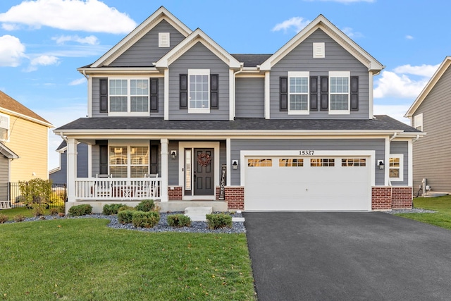 craftsman-style home with a porch, a front yard, and a garage