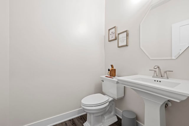 bathroom featuring toilet and wood-type flooring