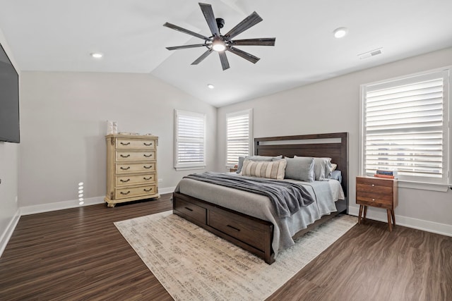 bedroom featuring ceiling fan, dark hardwood / wood-style floors, and vaulted ceiling