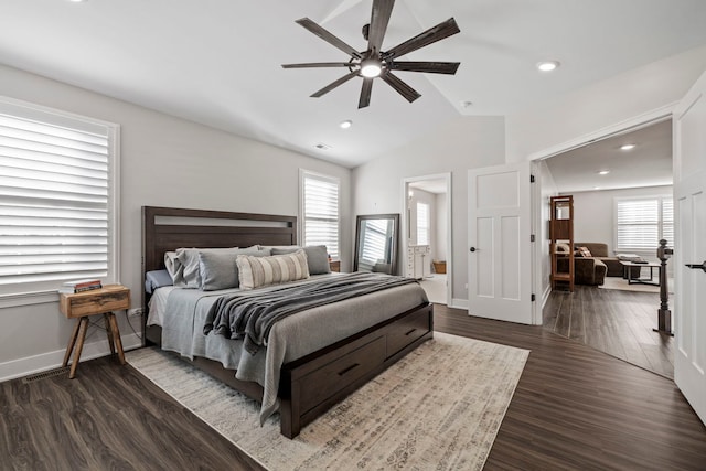 bedroom featuring multiple windows, lofted ceiling, ceiling fan, and dark wood-type flooring