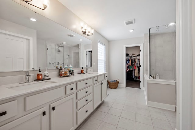 bathroom with tile patterned floors, vanity, and walk in shower