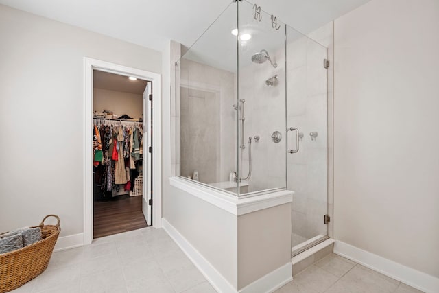 bathroom with tile patterned floors and walk in shower