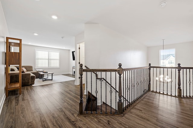 hallway featuring dark hardwood / wood-style flooring and a chandelier