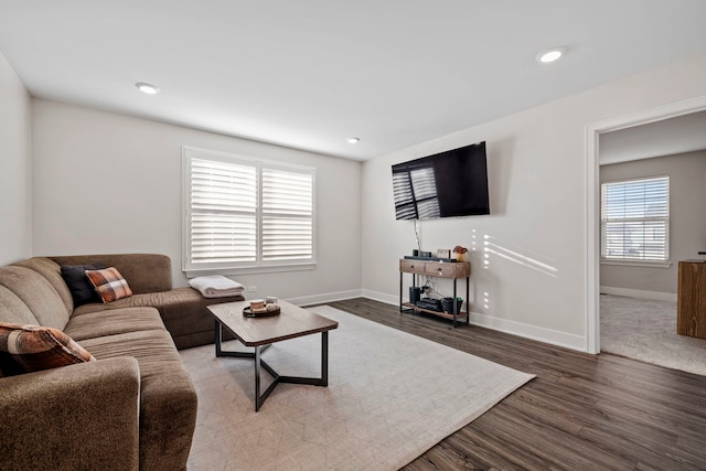 living room featuring dark hardwood / wood-style flooring and plenty of natural light