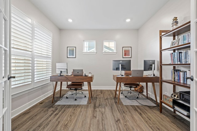 office space featuring plenty of natural light and dark wood-type flooring