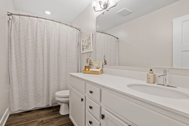 bathroom with vanity, curtained shower, toilet, and wood-type flooring