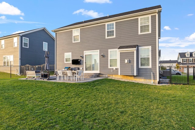 rear view of house with a yard and a patio