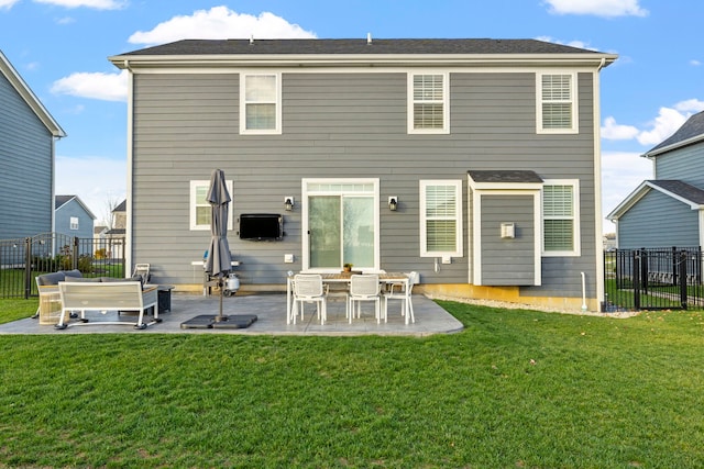 rear view of property featuring a patio area and a lawn