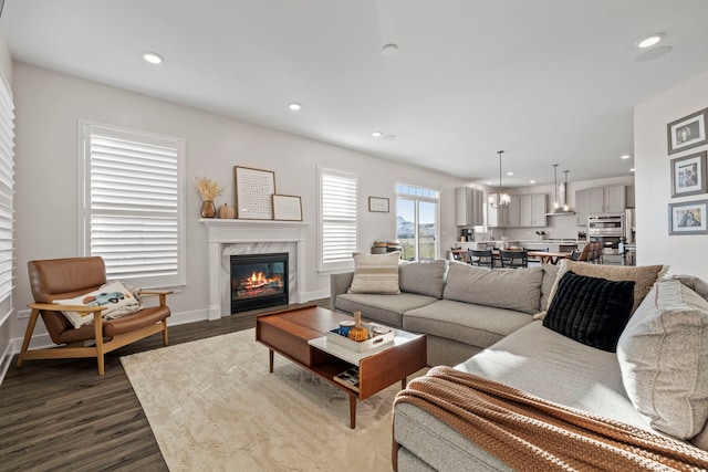 living room with hardwood / wood-style flooring and a premium fireplace