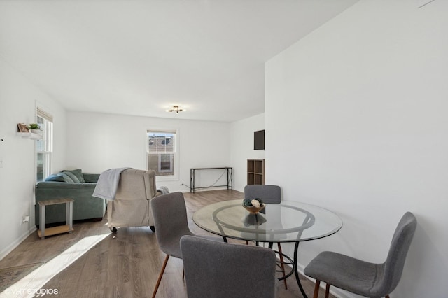 dining space with a wealth of natural light and light wood-type flooring