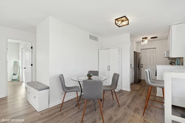 dining area featuring light wood-type flooring