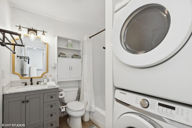 full bathroom with vanity, shower / bathtub combination with curtain, toilet, and stacked washer / dryer