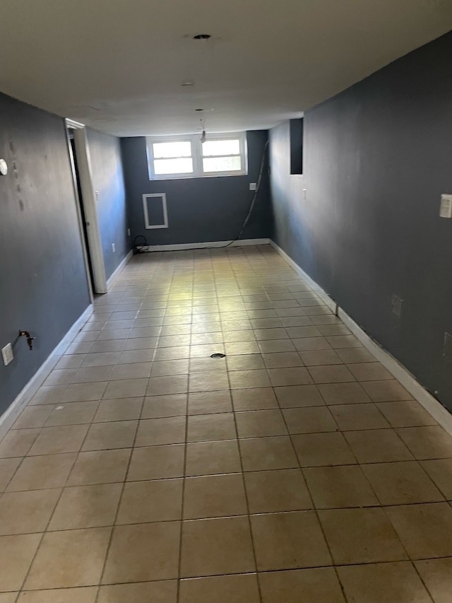 basement featuring light tile patterned floors