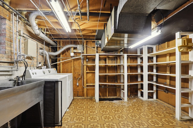 basement with sink and washer and clothes dryer