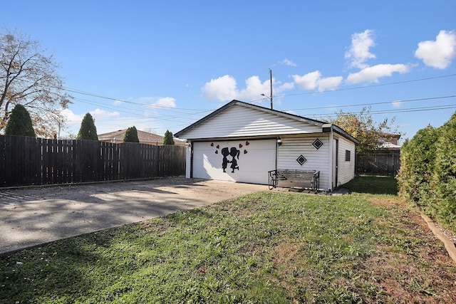 view of property exterior with an outbuilding, a garage, and a lawn