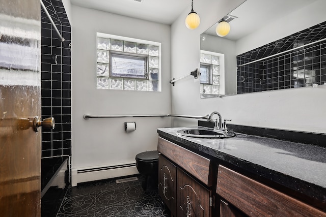 full bathroom with vanity, tiled shower / bath combo, tile patterned flooring, toilet, and baseboard heating