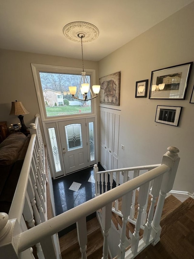 foyer entrance with a notable chandelier