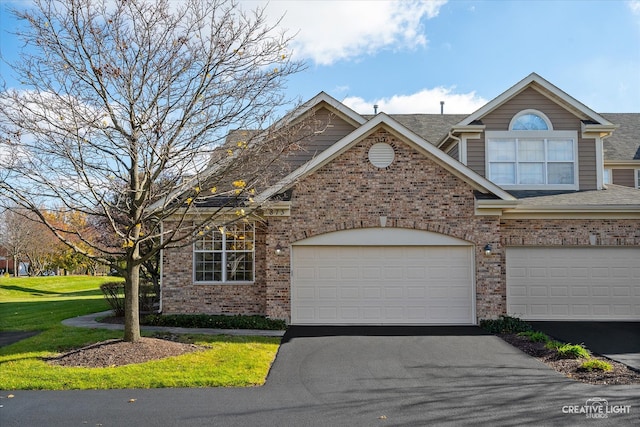 view of front of house with a front lawn and a garage